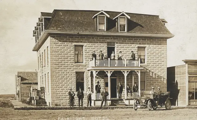 Fairlight Hotel with people and an early car